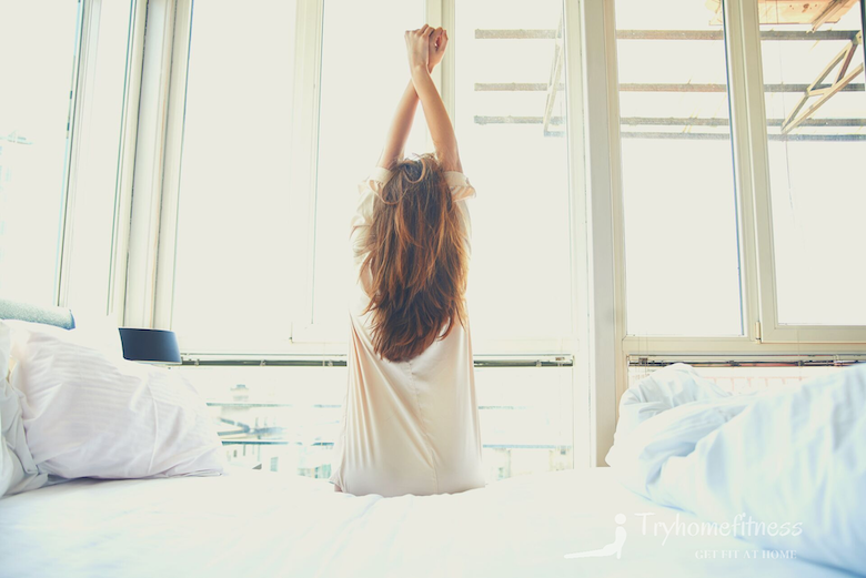 Woman stretching in the morning in her bedroom