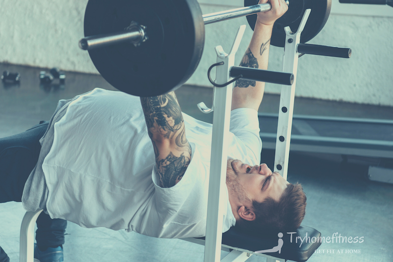 Overweight man using a weight bench