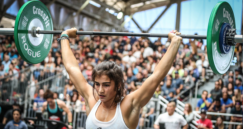 Woman using a Rogue barbell & weights for crosssfit