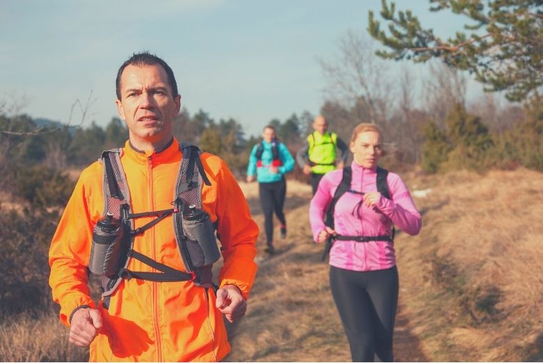 Group of 4 steady cardio running in the countryside