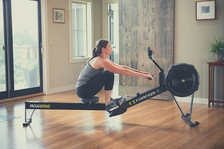Woman at home using, probably the best rowing machine, the Concept2 Model D