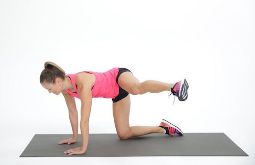 woman demonstrating fire hydrant underbutt exercises